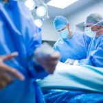 Surgeons performing operation in operation room at the hospital